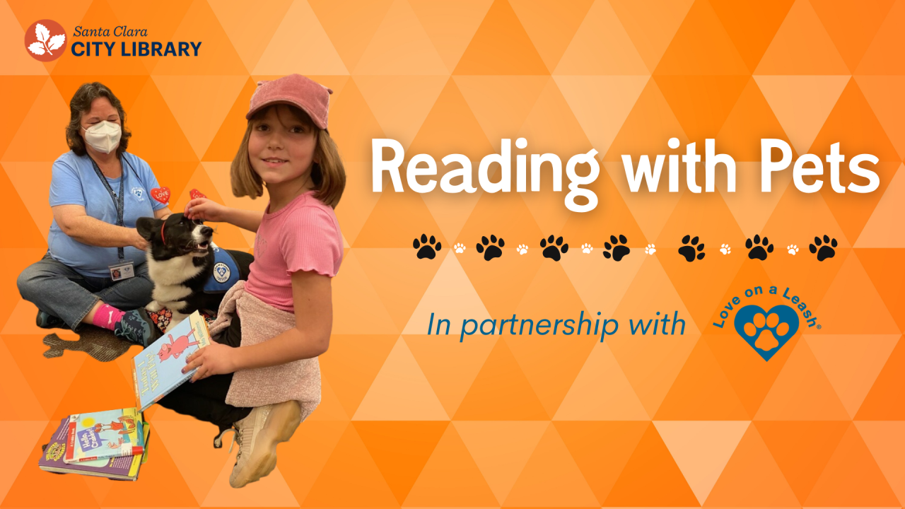 Young girl holding a book while petting a dog.